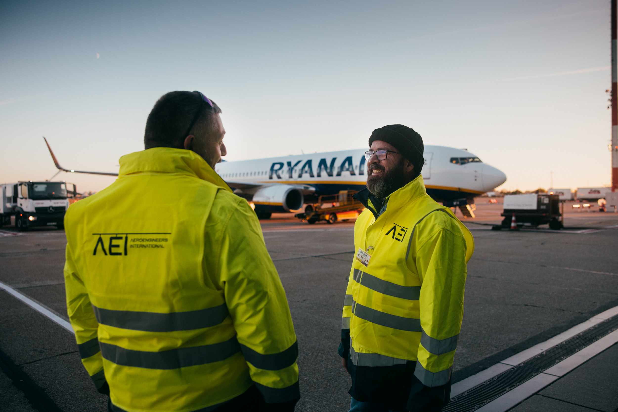 Two AEI technicians talking on the apron in front of an aircraft